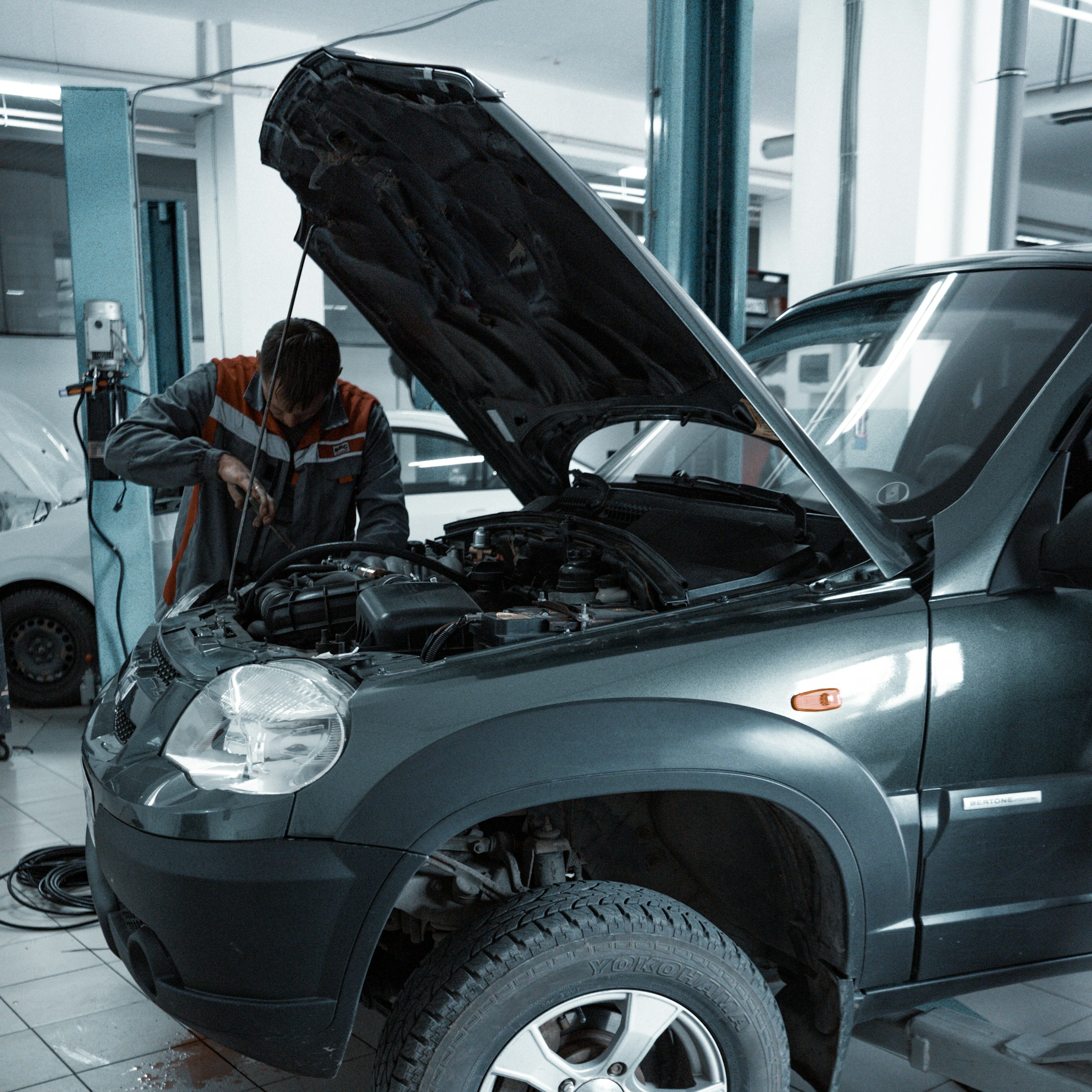 Mechanic working on a car in an auto repair shop