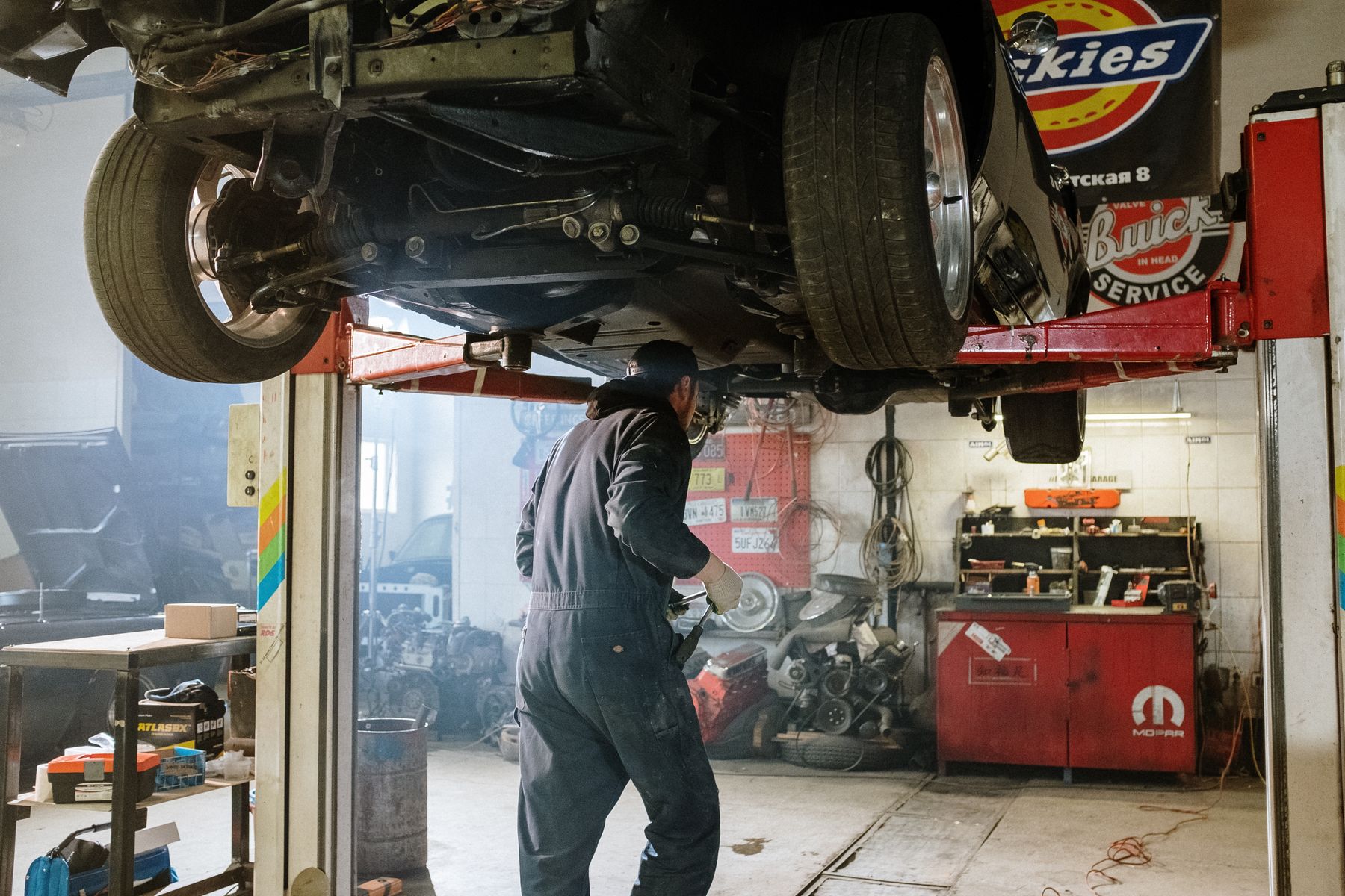 Car on a lift inside an auto repair shop